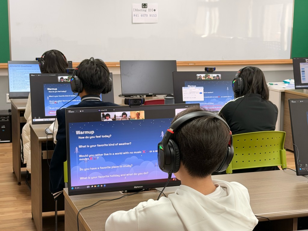 Students with headsets working through lesson slides